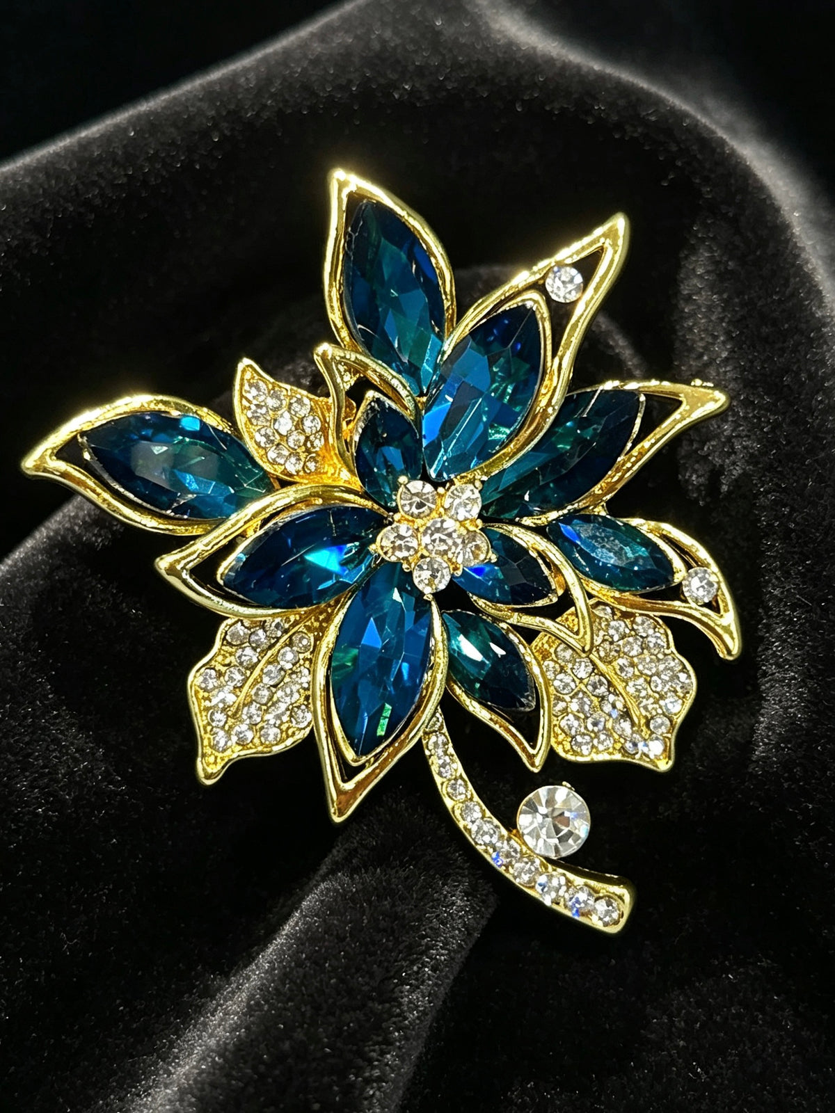 Crystal cluster brooch pin close-up on black velvet