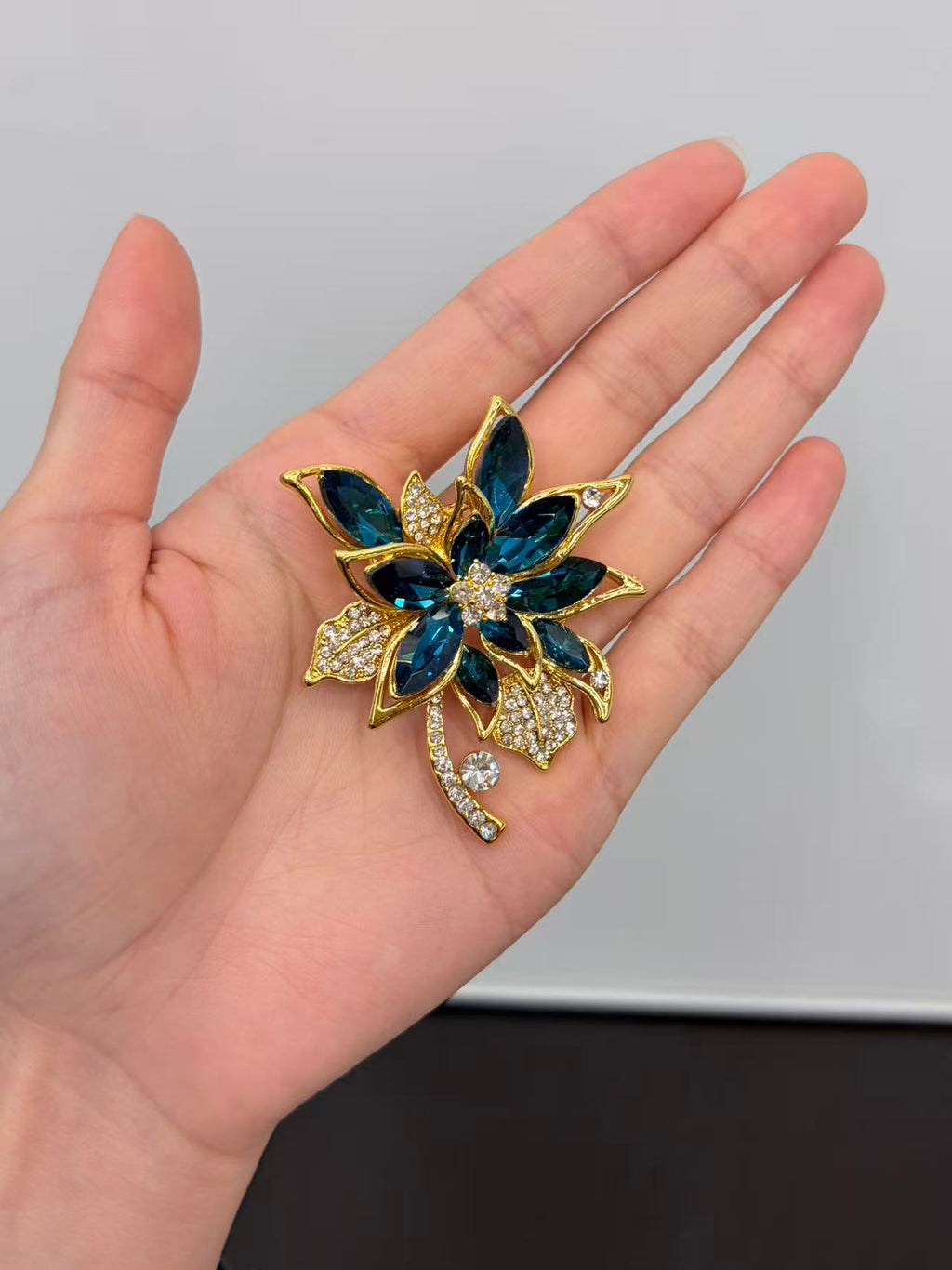 Crystal cluster brooch pin held in hand to show actual size