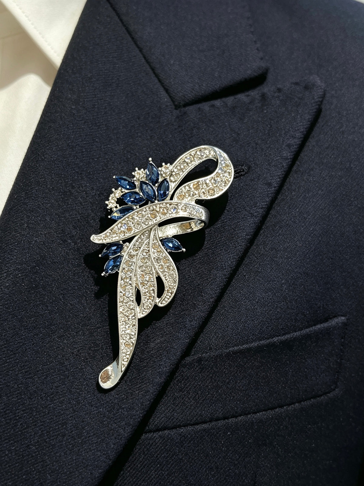 Crystal floral brooch pin worn on a dark suit lapel