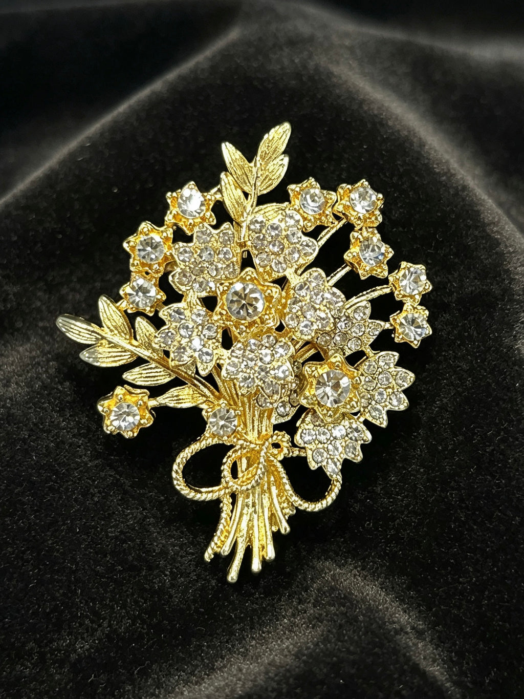 Crystal flower bouquet brooch pin close-up on black velvet