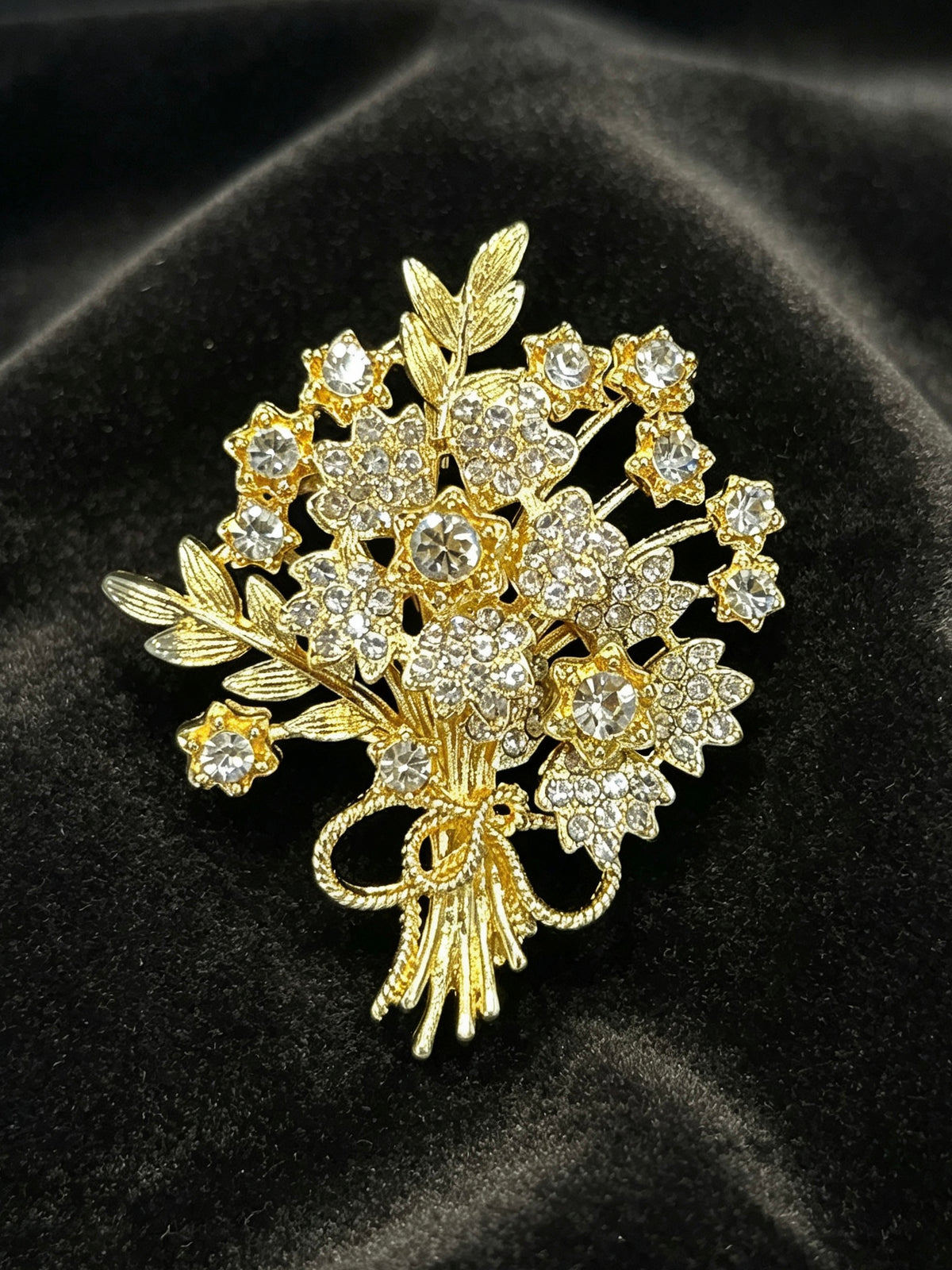 Crystal flower bouquet brooch pin close-up on black velvet