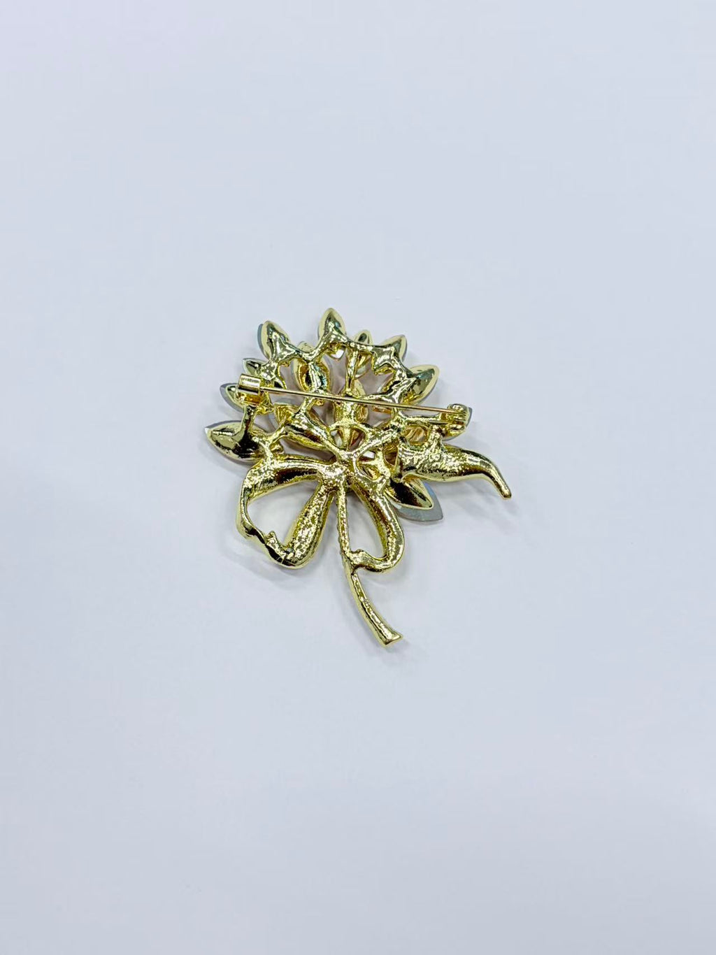 Crystal flower bow brooch pin angled view on white background
