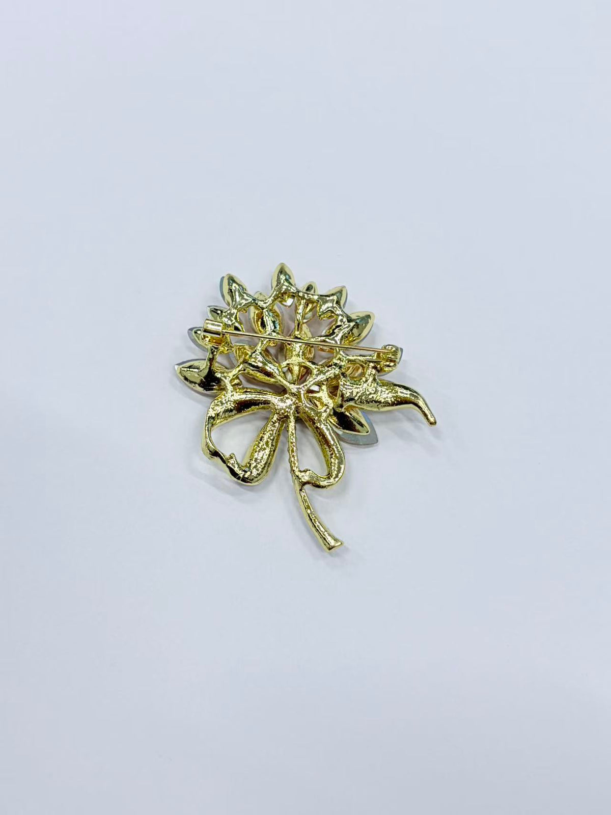 Crystal flower bow brooch pin angled view on white background