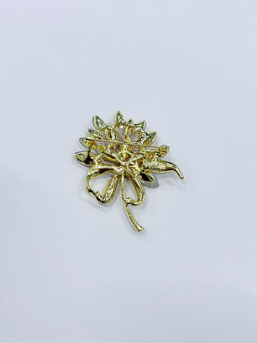 Crystal flower bow brooch pin angled view on white background