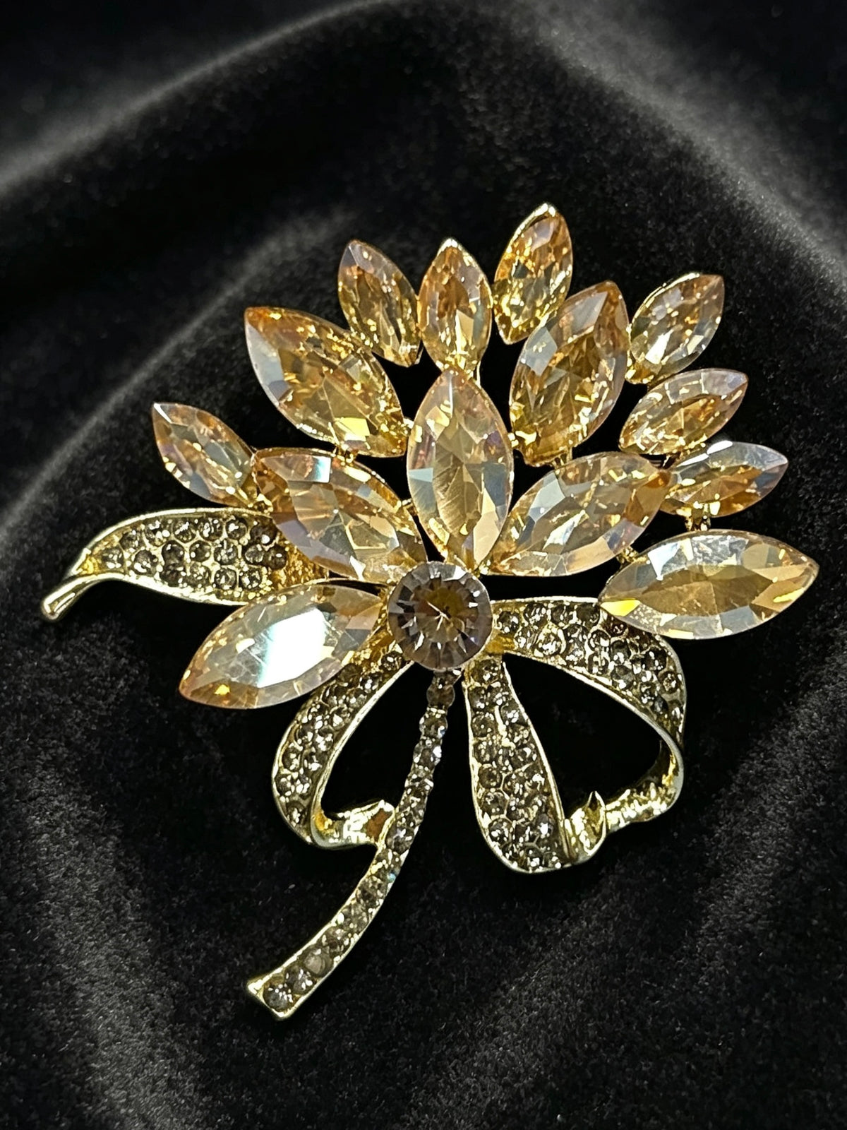 Crystal flower bow brooch pin close-up on black velvet