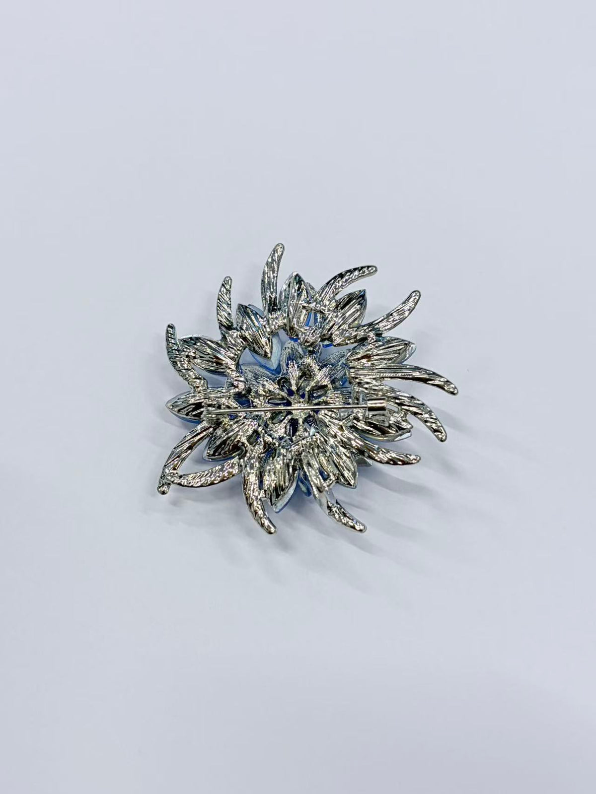 Crystal flower brooch pin angled view on white background