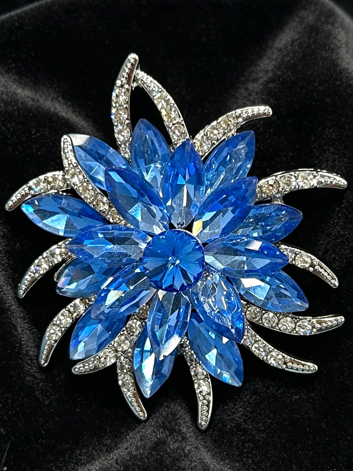 Crystal flower brooch pin close-up on black velvet