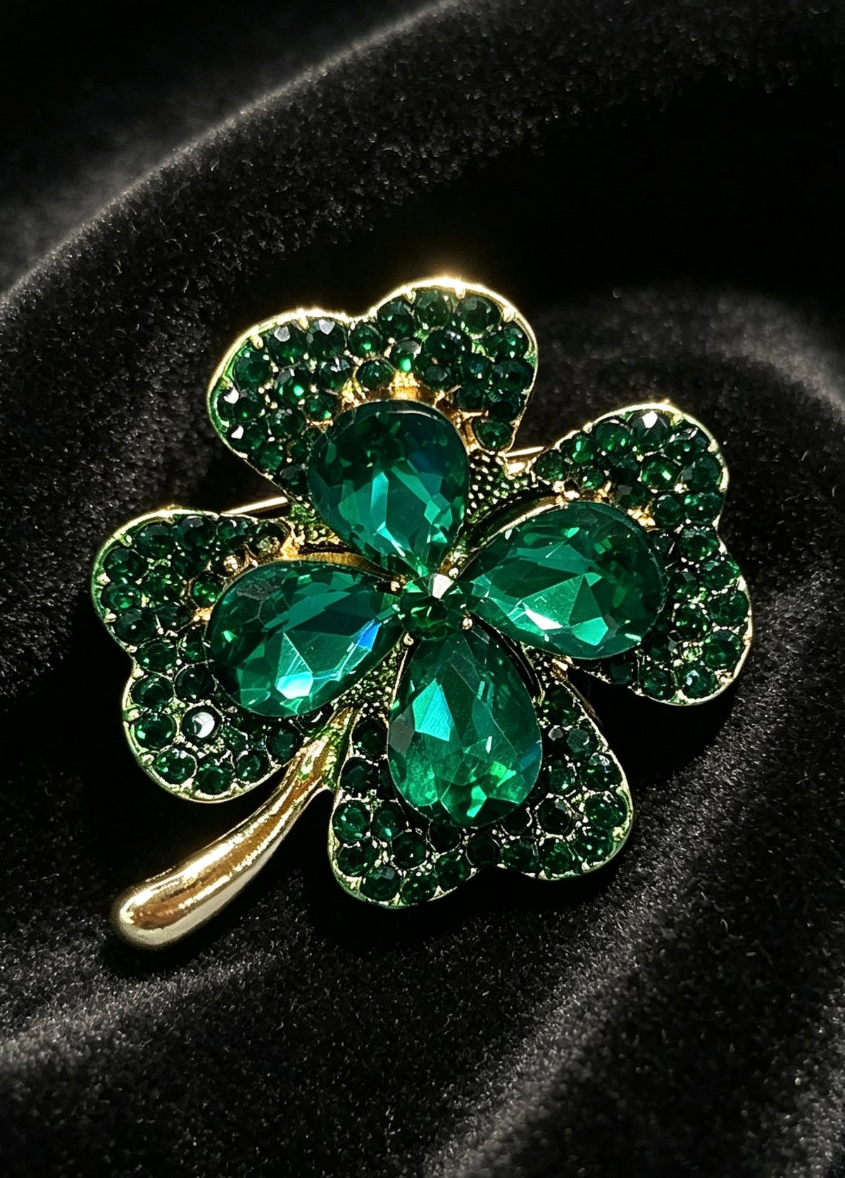 Crystal four leaf clover brooch pin close-up on black velvet