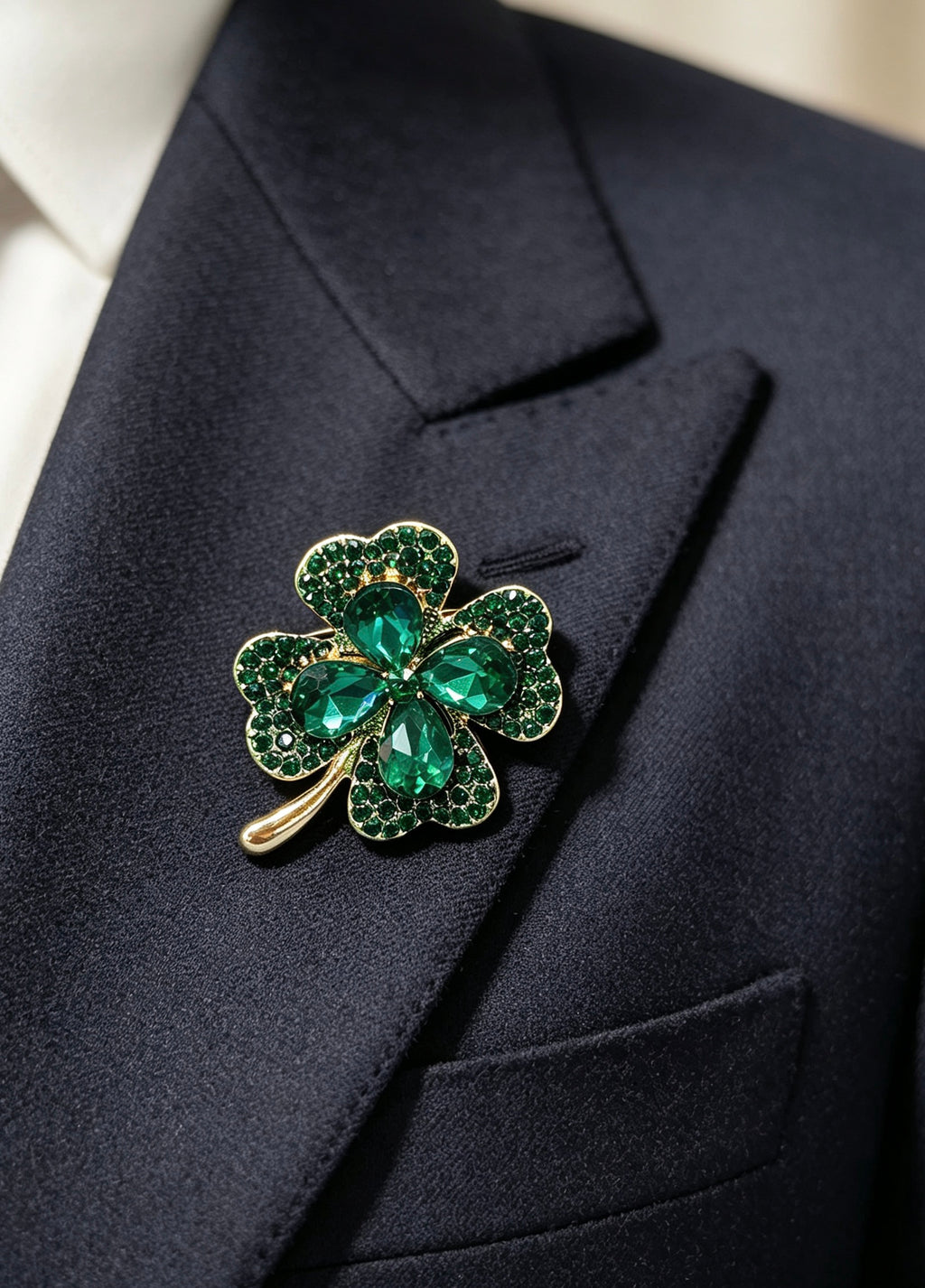 Crystal four leaf clover brooch pin worn on a dark suit lapel