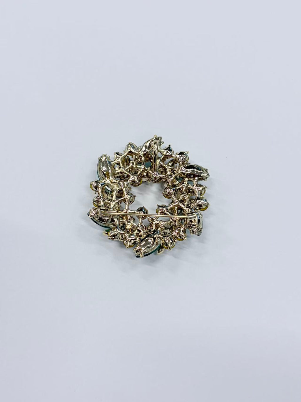 Crystal leaf wreath brooch pin angled view on white background