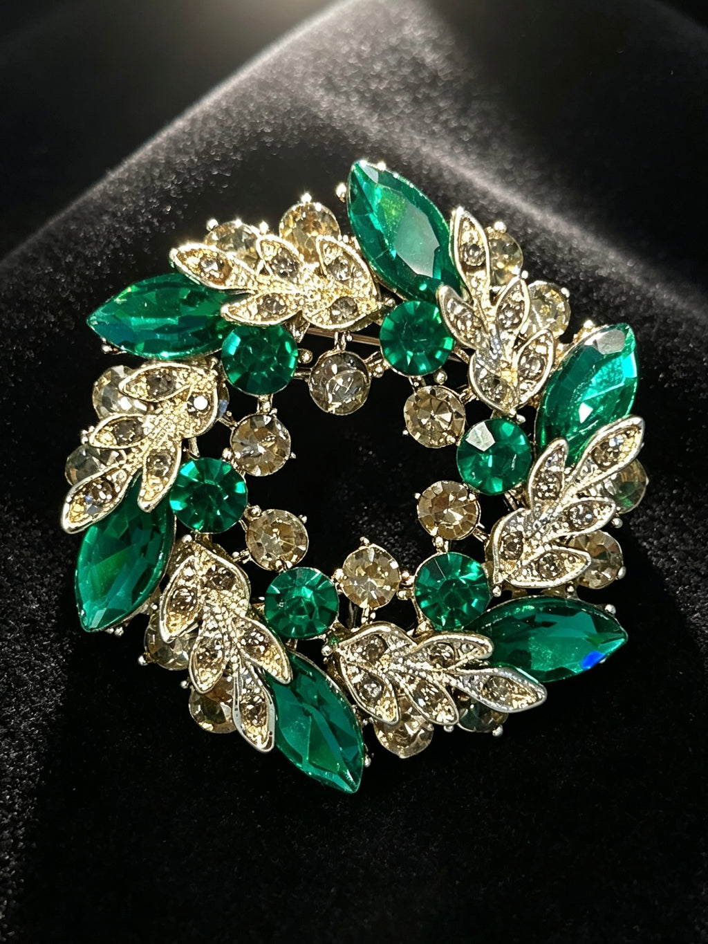 Crystal leaf wreath brooch pin close-up on black velvet