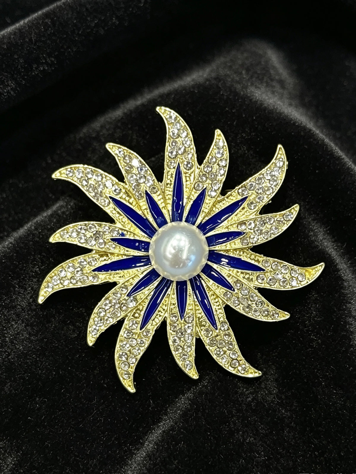 Crystal sunburst brooch pin close-up on black velvet