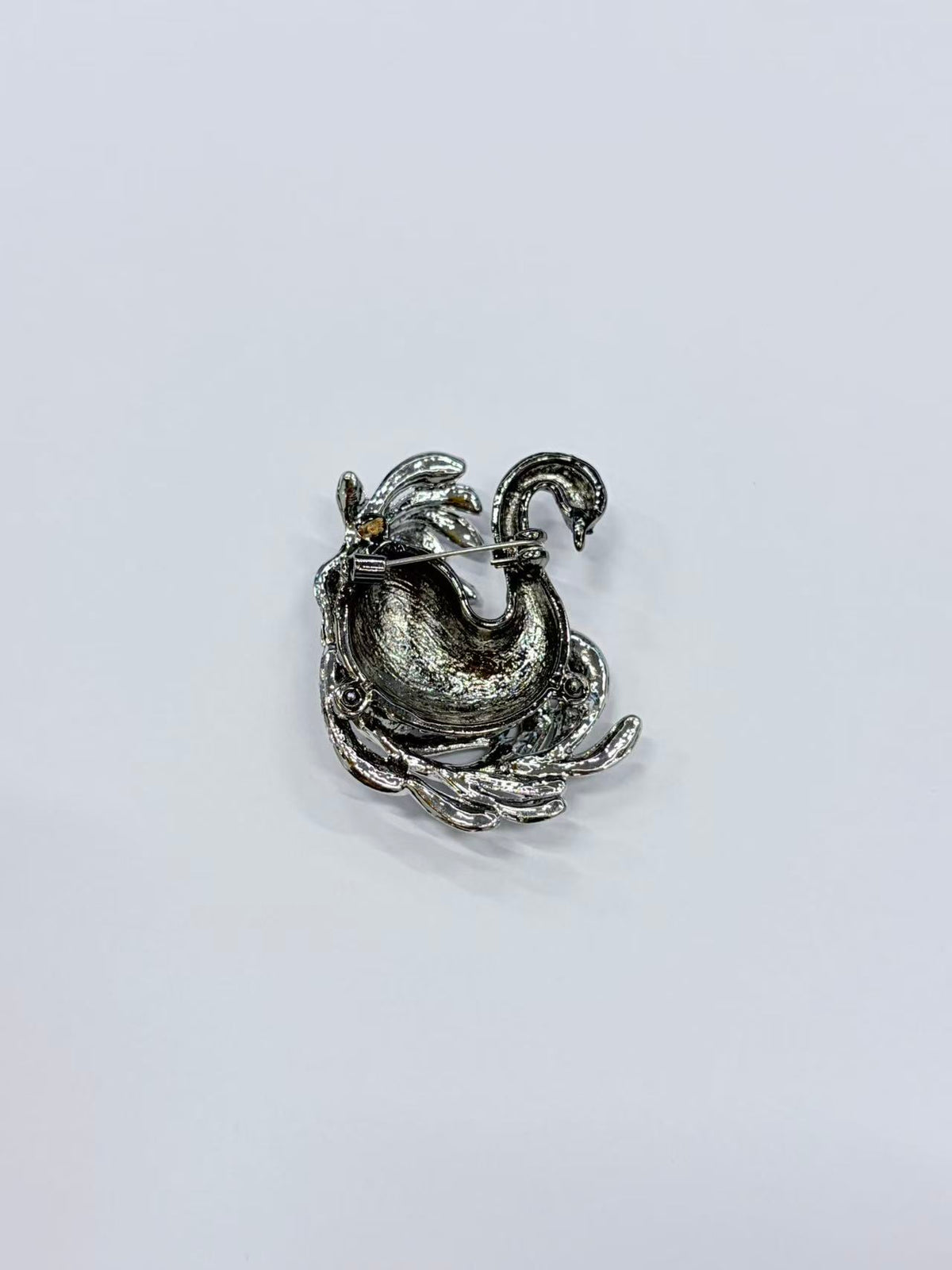 Crystal swan brooch pin angled view on gray background
