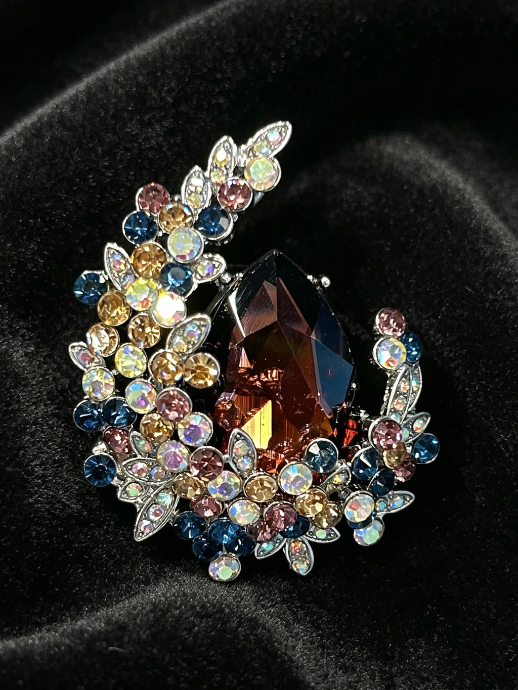 Crystal teardrop floral brooch pin close-up on black velvet